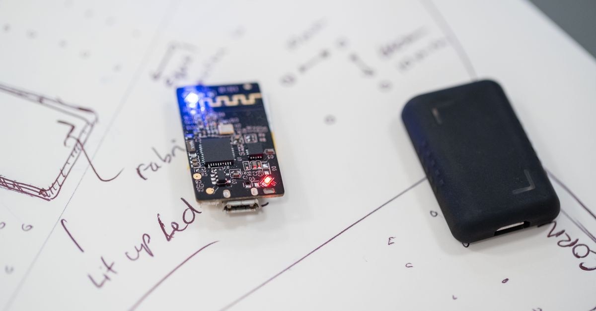 Close-up of a microprocessor and circuit board placed on technical design sketches.