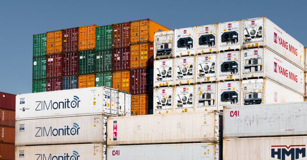 Colorful stacked shipping containers at Hamburg port, Germany, showcasing global trade logistics.