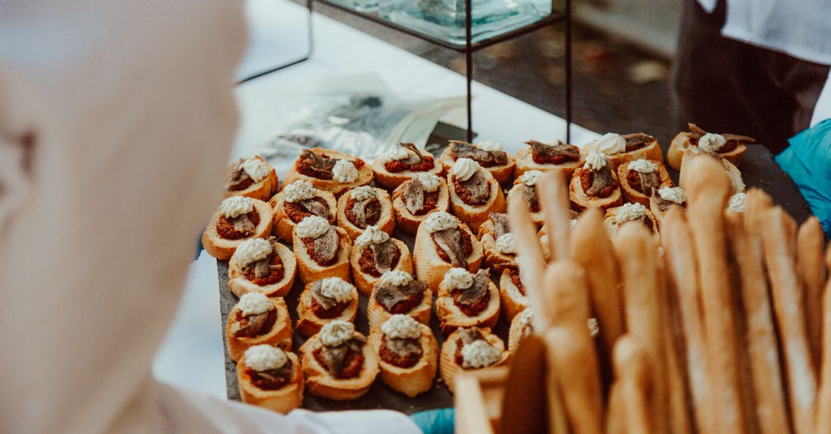 A selection of gourmet appetizers elegantly presented at an outdoor catering event, ideal for culinary themes.