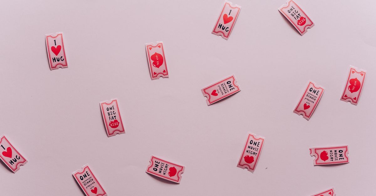 Romantic coupons on a subtle pink surface, symbolizing love and affection.