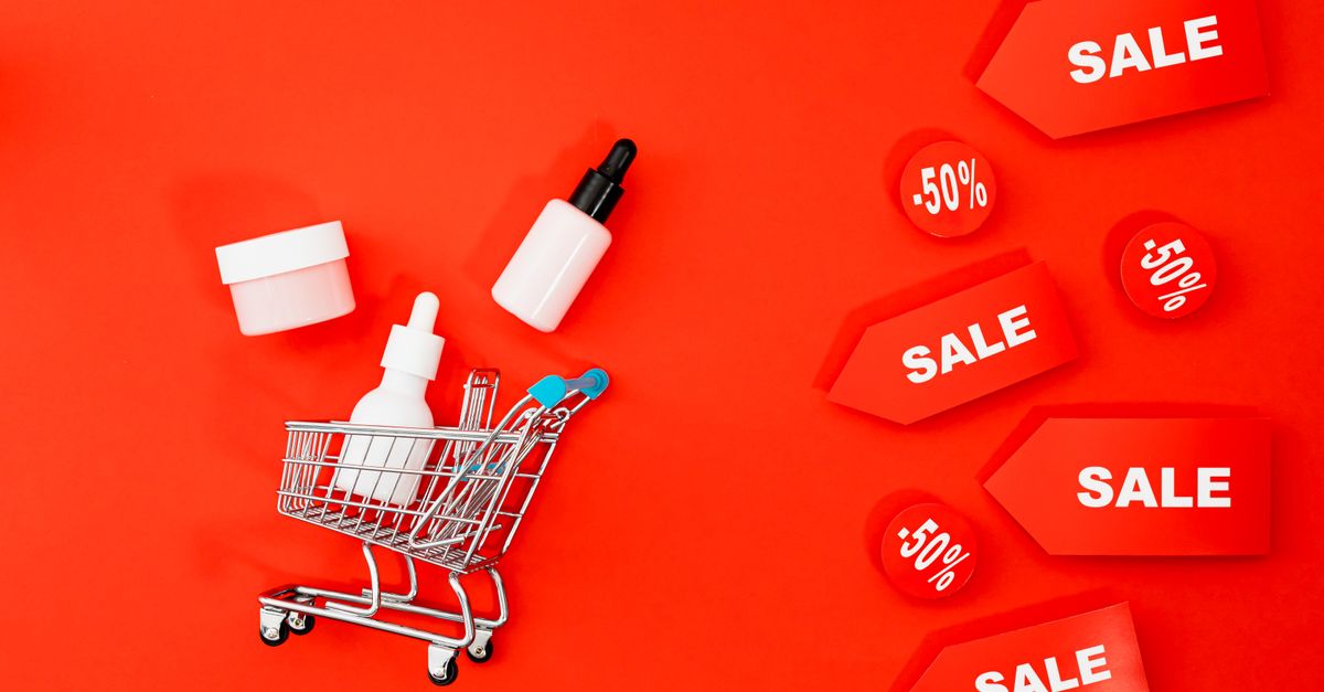 Skincare items in mini cart with sale tags on red background. Perfect for Black Friday ads.
