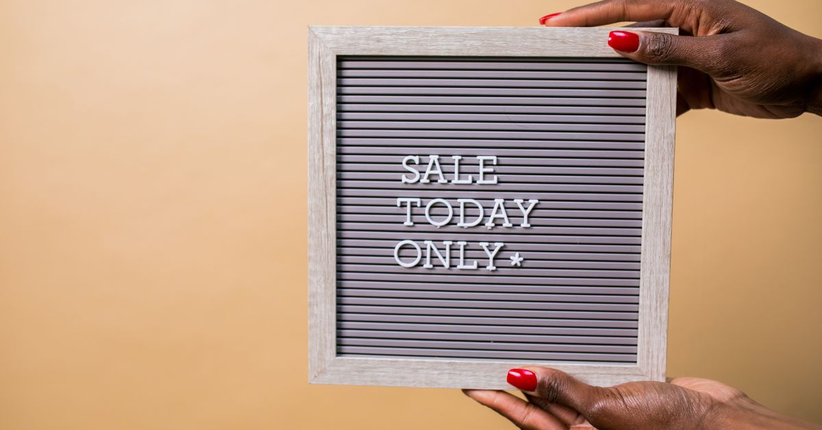 Hands with red nails holding a sign reading 'SALE TODAY ONLY' on a beige background.