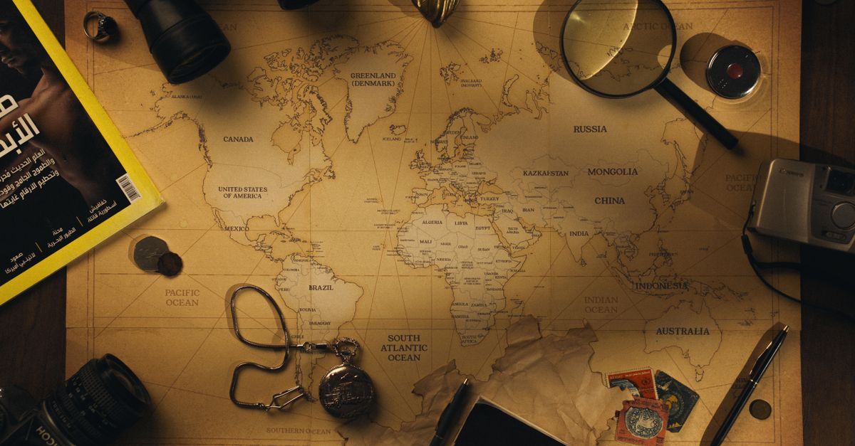 Flatlay of exploration tools and a vintage world map, capturing the essence of adventure.