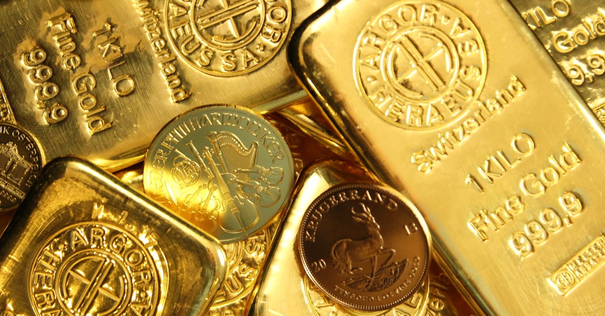 Close-up of shiny gold bars and coins, representing wealth and fortune.