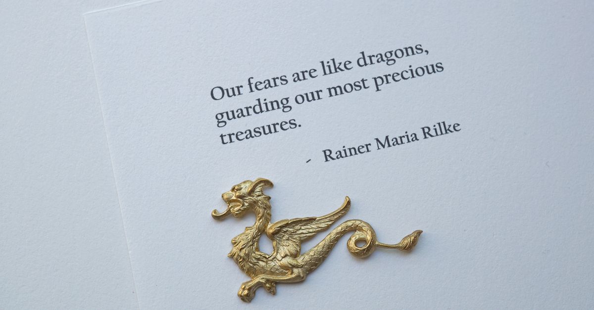 A Rainer Maria Rilke quote with a decorative golden dragon, symbolizing courage and protection.