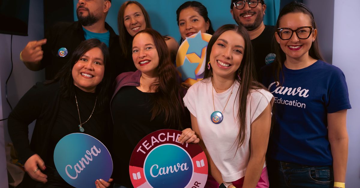 Happy group of educators attending a Canva workshop, showing signs and smiles.