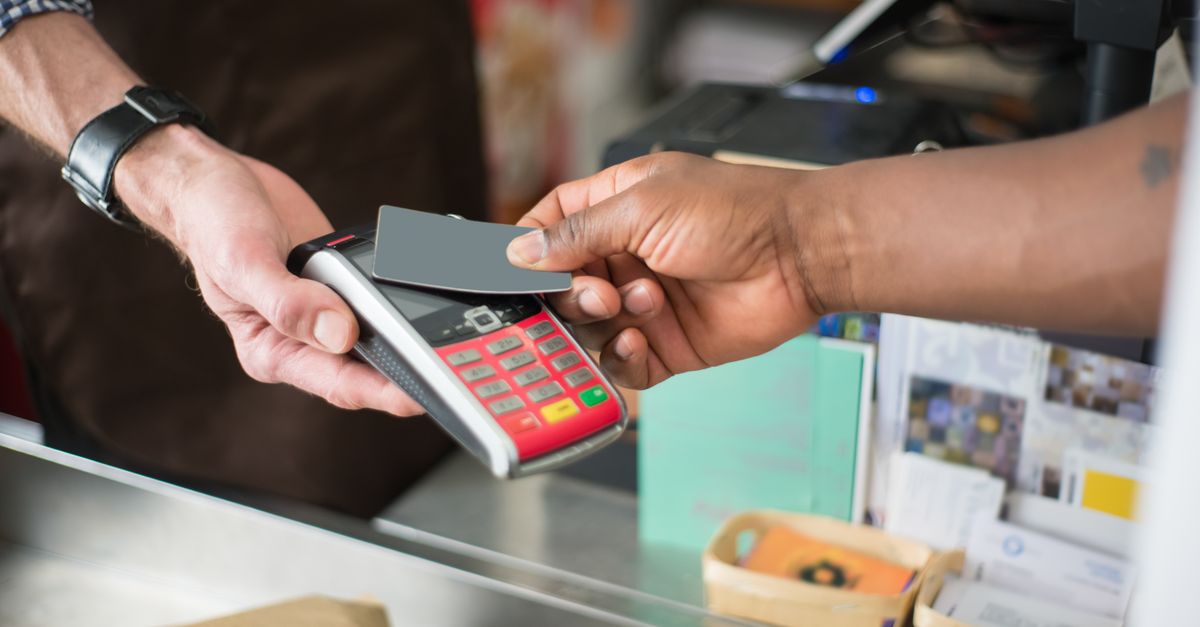 Close-up of a contactless payment transaction in a retail setting.