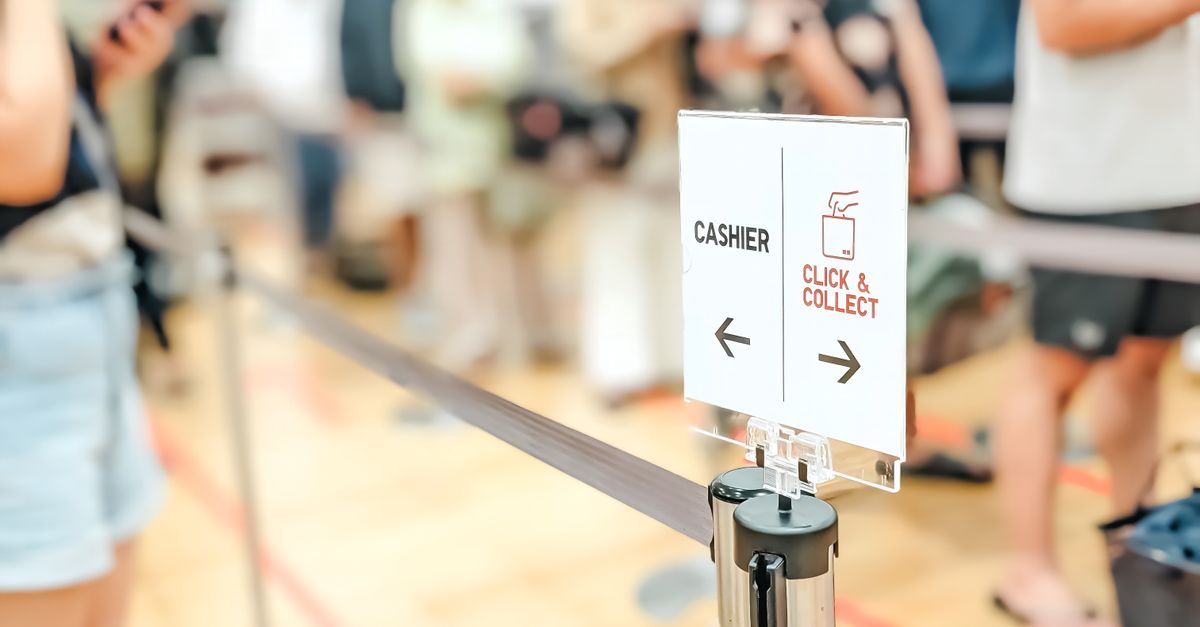 Blurred indoor scene showing a queue with a click and collect sign.