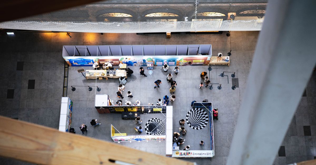 Top view of a bustling indoor exhibition space in Taipei, Taiwan.
