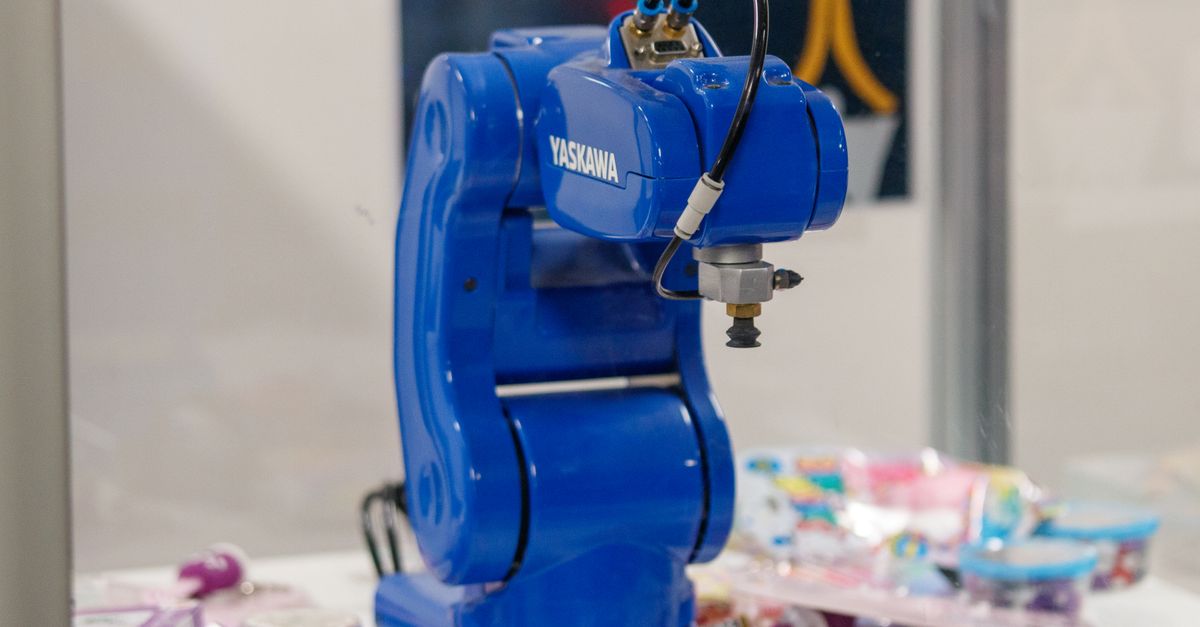 A blue Yaskawa industrial robot arm on display, showcasing advanced technology and robotics.