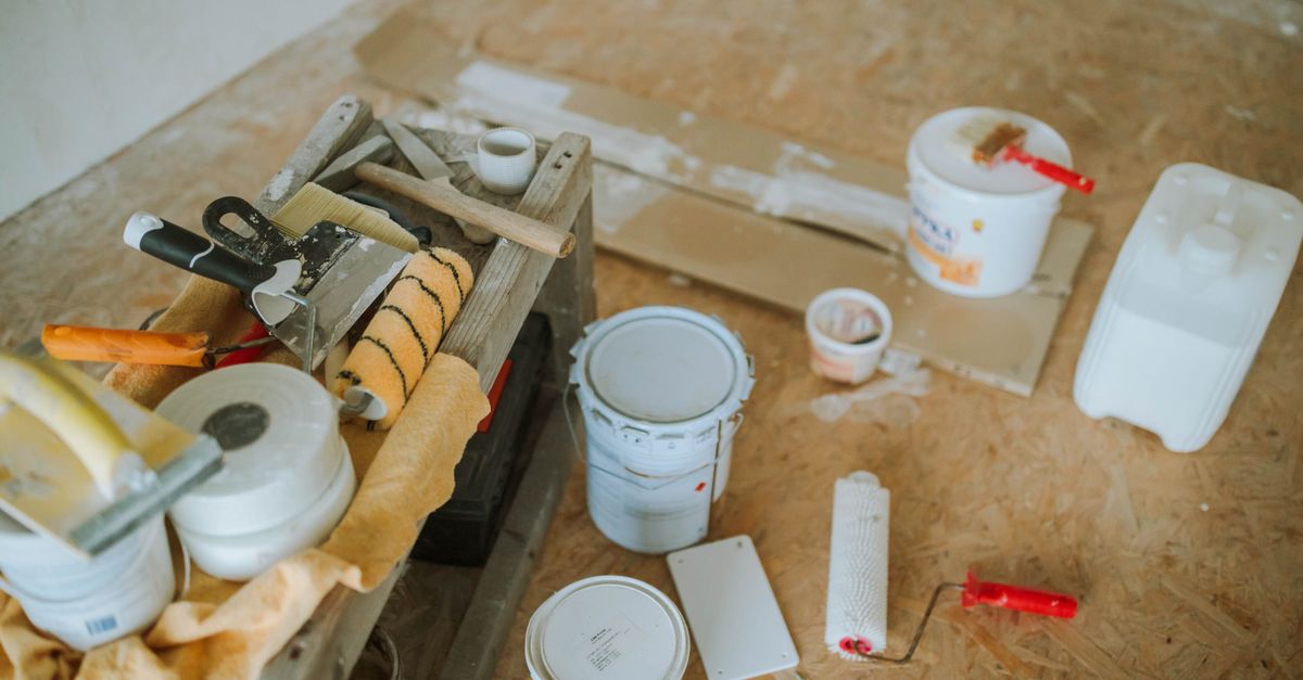 Overhead shot of tools and paint supplies for a home renovation project.