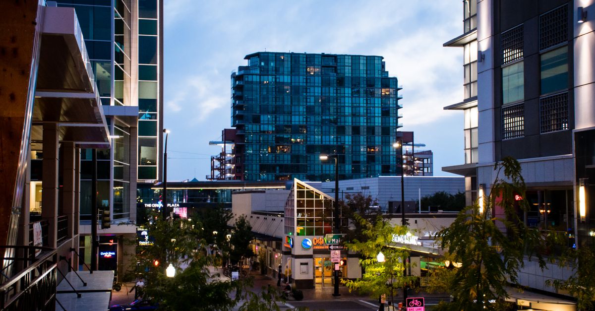 Modern cityscape featuring skyscrapers and bustling streets at twilight.