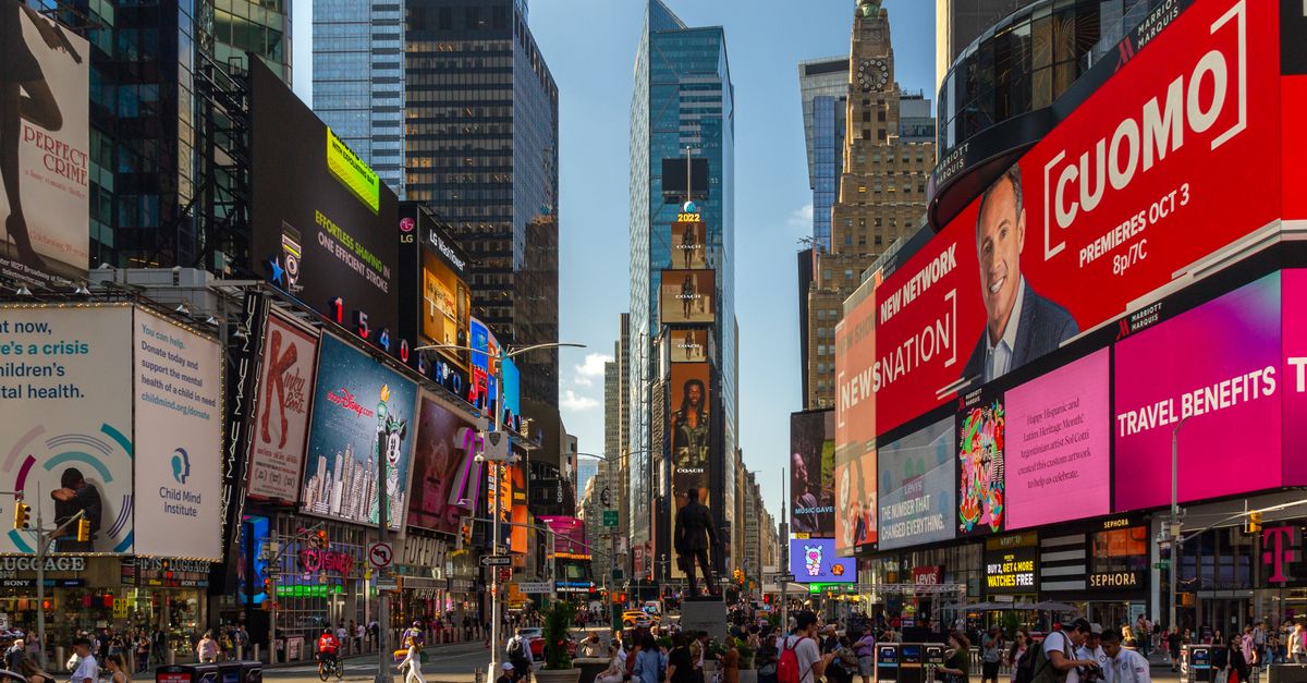 Captured on a sunny day, Times Square buzzes with urban energy and colorful billboards.