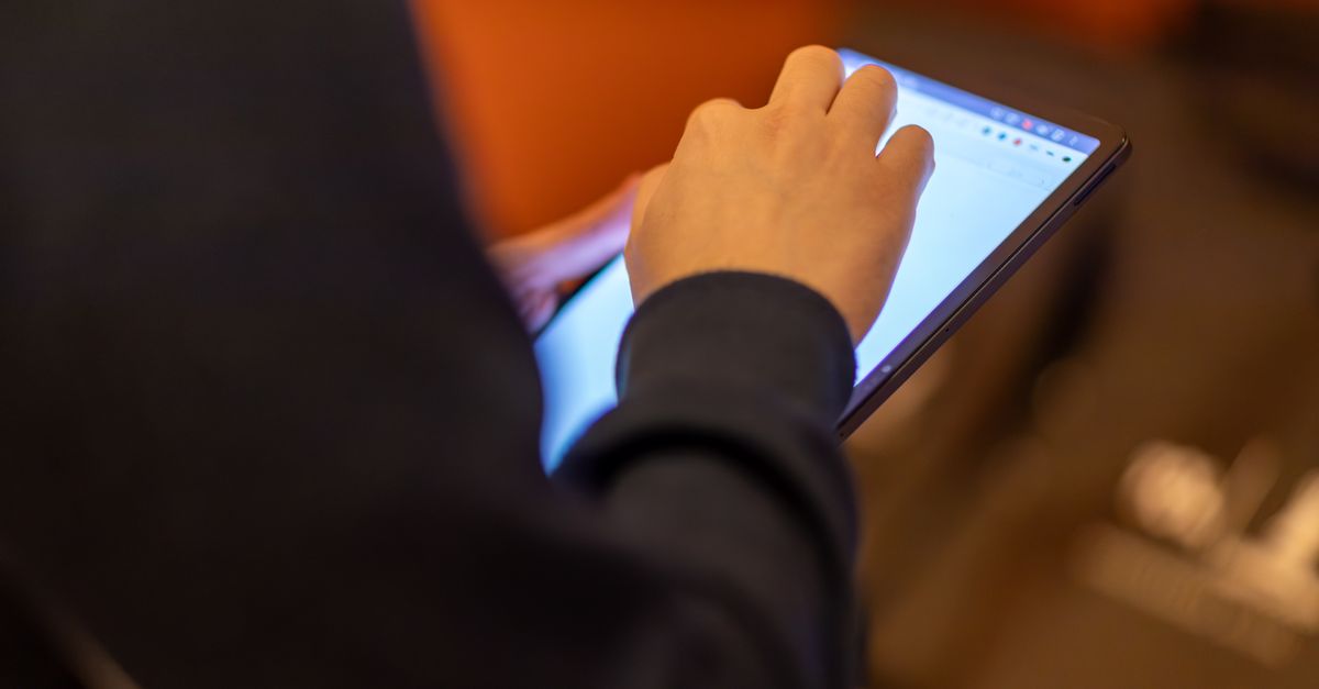 Close-up of a person using a tablet, showcasing technology and modern lifestyle.