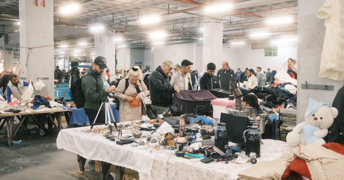 Bargain hunters explore diverse items at an indoor flea market in Istanbul, Turkiye.