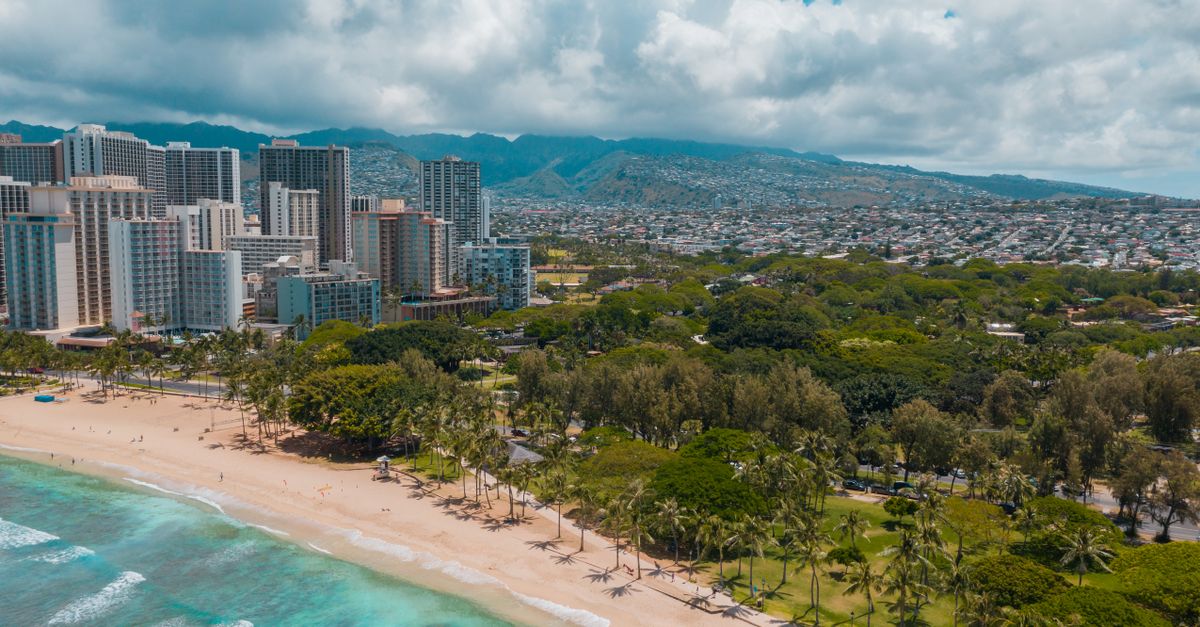 Stunning aerial view of Waikiki Beach with the skyscrapers of Honolulu in the backdrop.