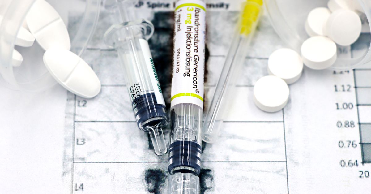 Close-up of syringes and pills on a bone density exam sheet, depicting osteoporosis treatment.