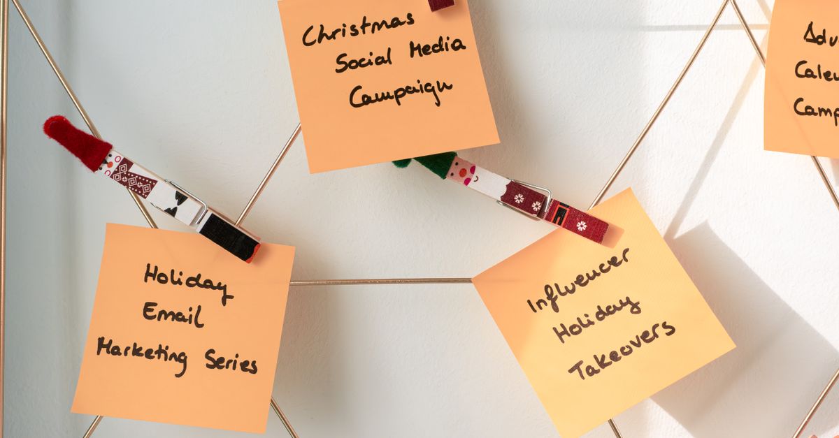 Sticky notes with holiday marketing ideas for Christmas social media and email campaigns.