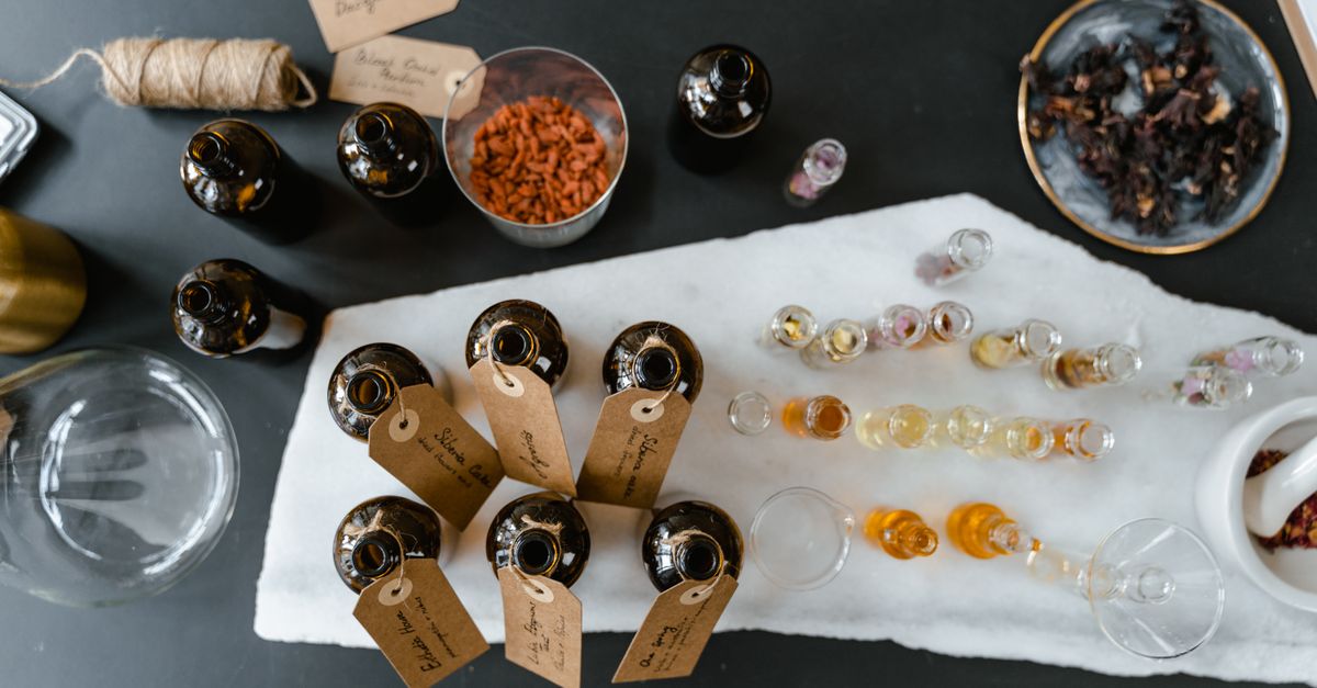 A collection of essential oils and natural ingredients on a marble surface for aromatherapy.