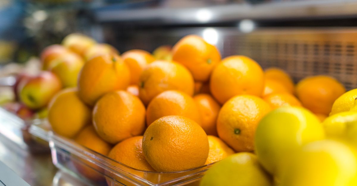 A vibrant display of fresh oranges and lemons in a market setting, emphasizing health and freshness.
