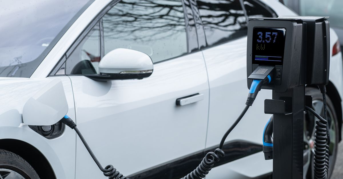 Close-up of an electric vehicle charging at a station, showcasing energy-efficient technology.