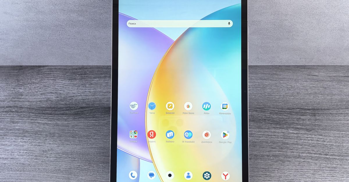 Front view of a modern tablet showing a colorful home interface with various app icons on display.
