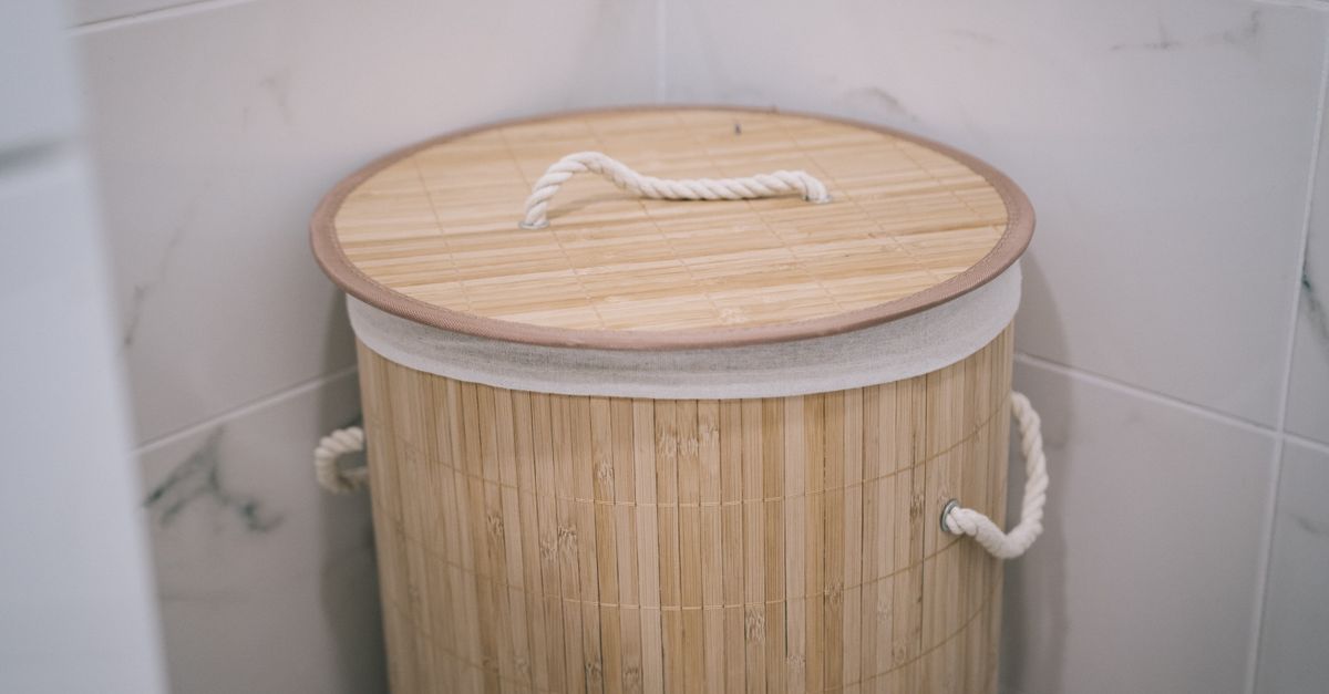 A stylish bamboo laundry basket adds a natural touch to a modern bathroom design.