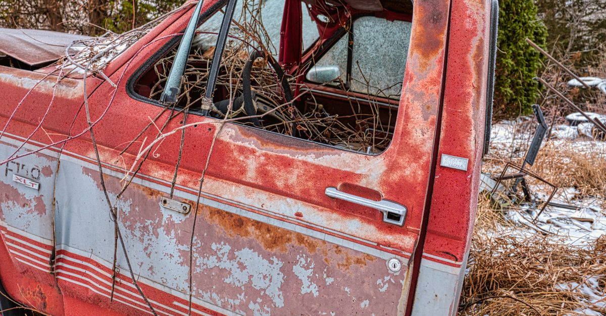 An old, rusty vintage truck abandoned in a snowy field in Wabasha, MN.