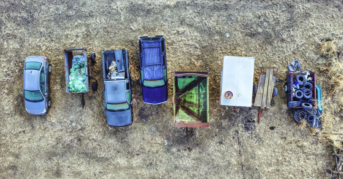 Bird's-eye view of multiple parked vehicles and trailers on a rural area in Minnesota, USA.
