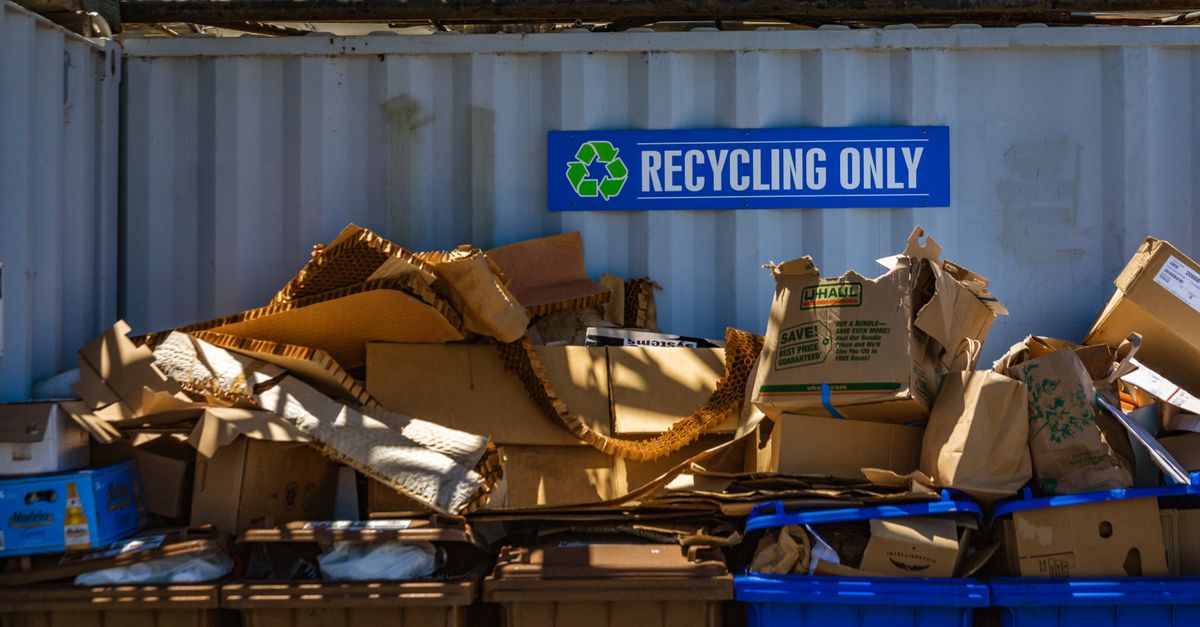 Recycling area filled with cardboard and paper materials, promoting sustainability.