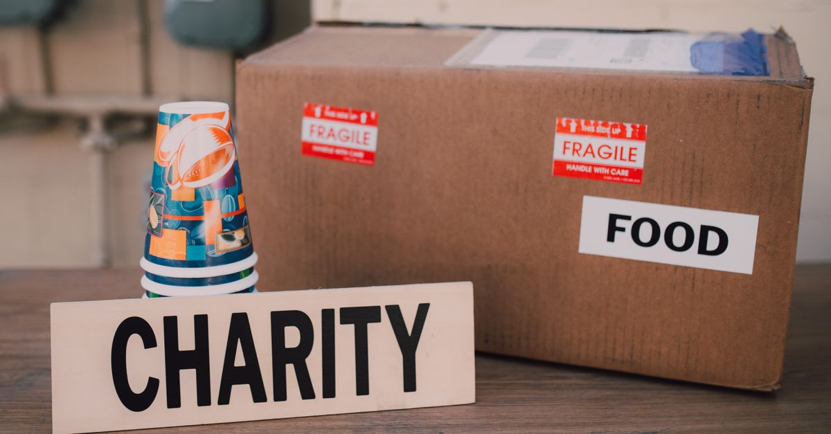 Image of a charity donation box filled with food supplies and paper cups.