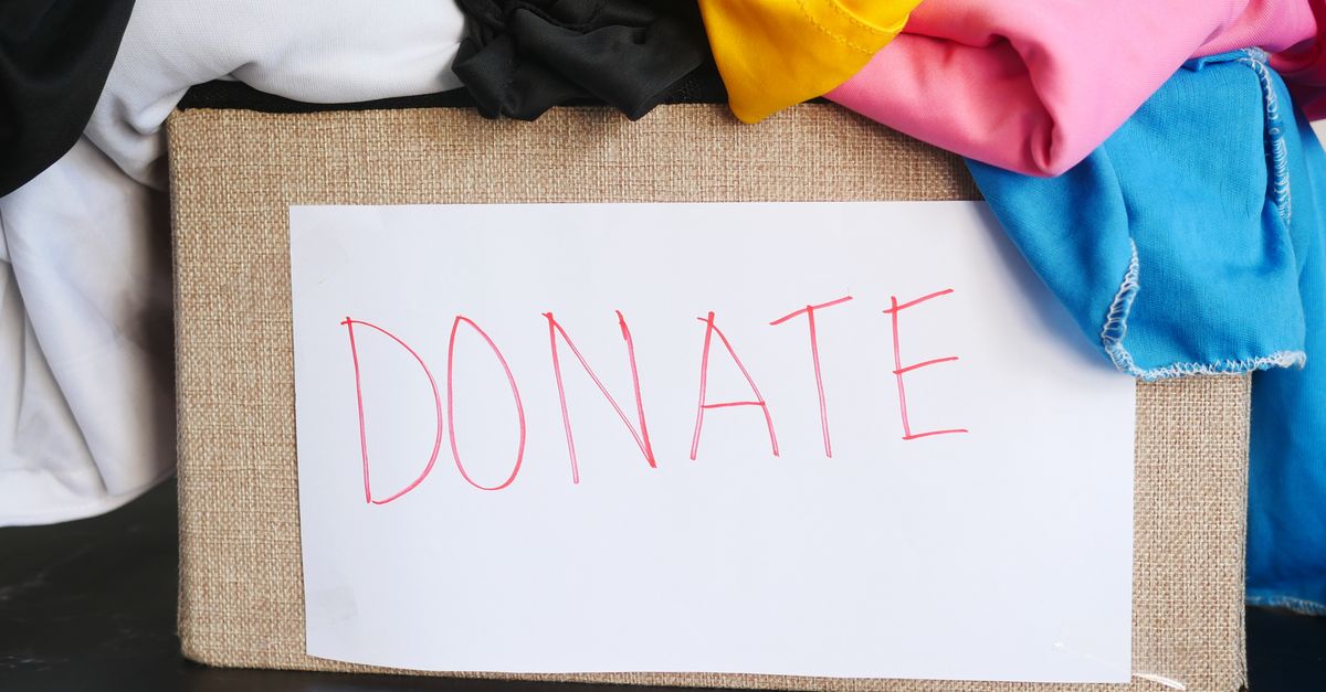 A donation box filled with colorful clothing, symbolizing charity and community support.