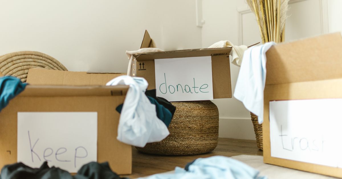 Cardboard boxes labeled keep, donate, and trash for effective home organization.