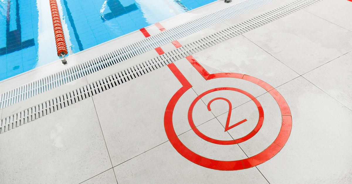 Close-up of the number two marking beside an outdoor swimming pool lane.