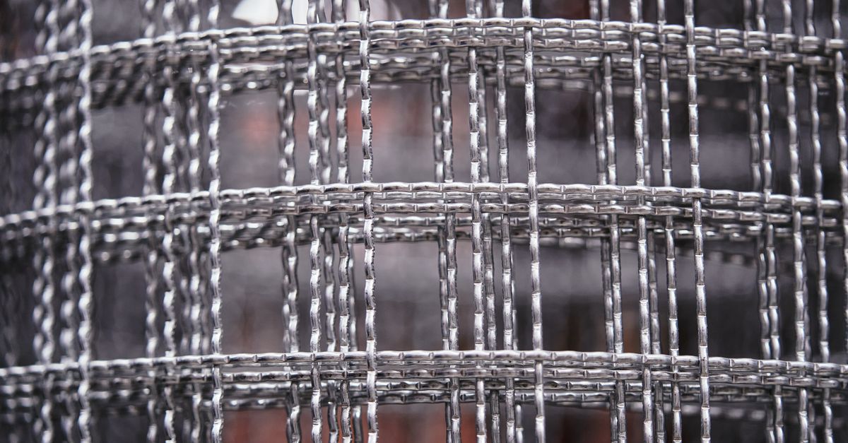 Detailed close-up of a metal wire mesh with intricate patterns and textures, ideal for industrial design concepts.