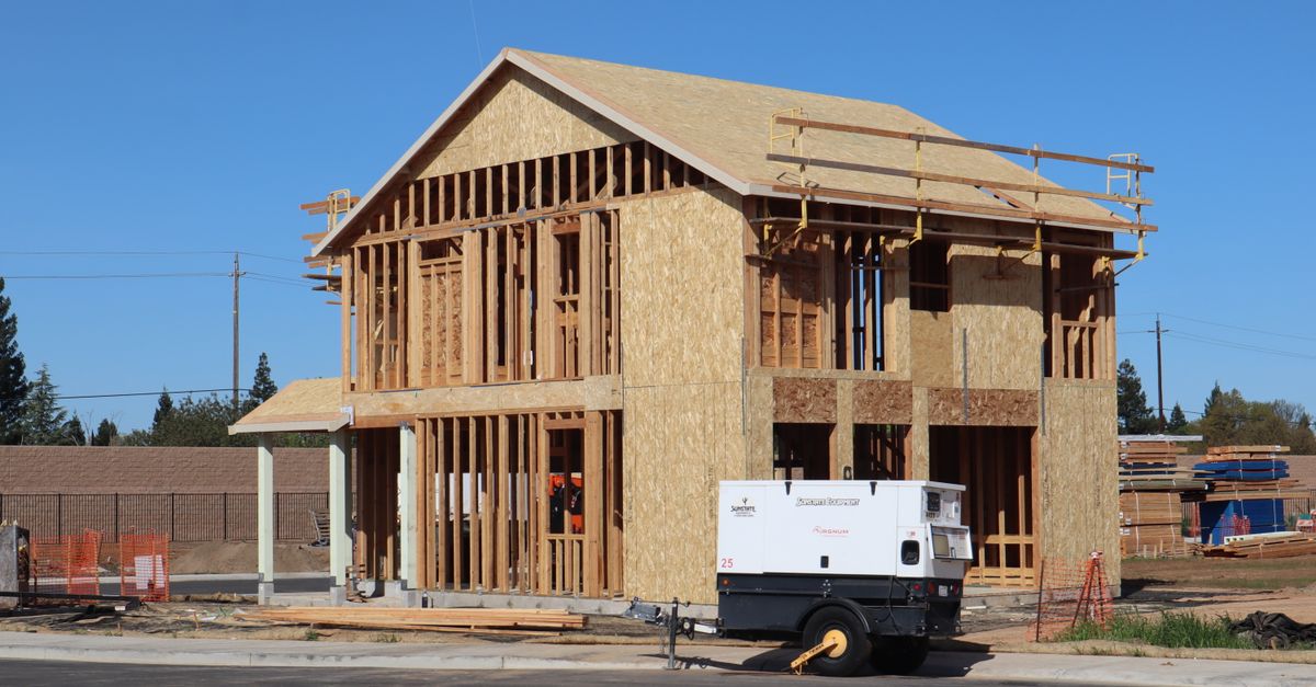 A new house under construction in Elk Grove, showing wooden framing and building materials.