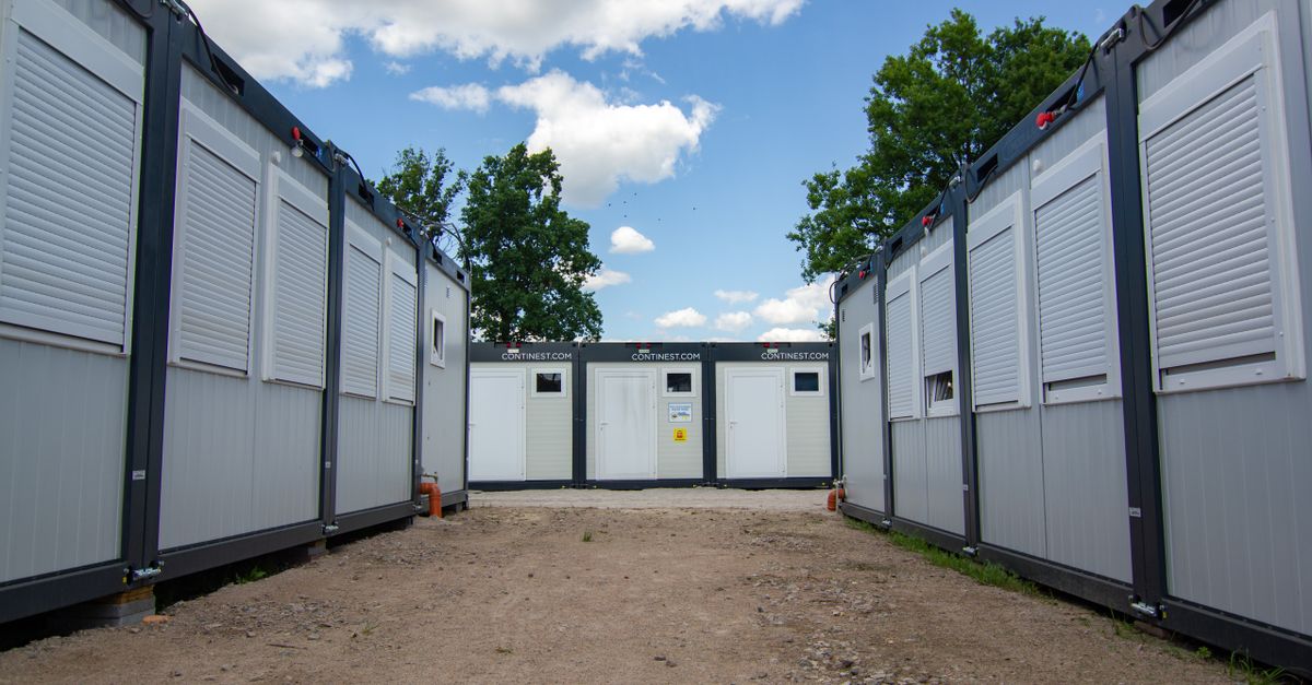 Photo of modern office containers with shutters under a blue sky.