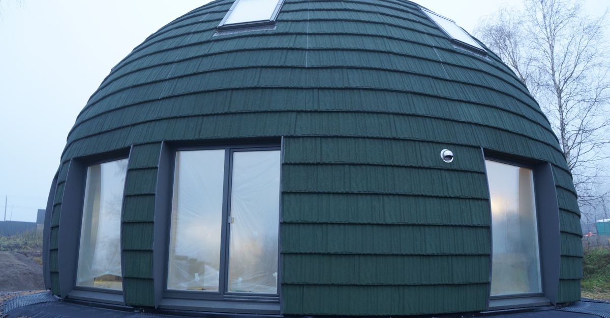 Unique green dome house on a foggy day, showcasing contemporary architecture.