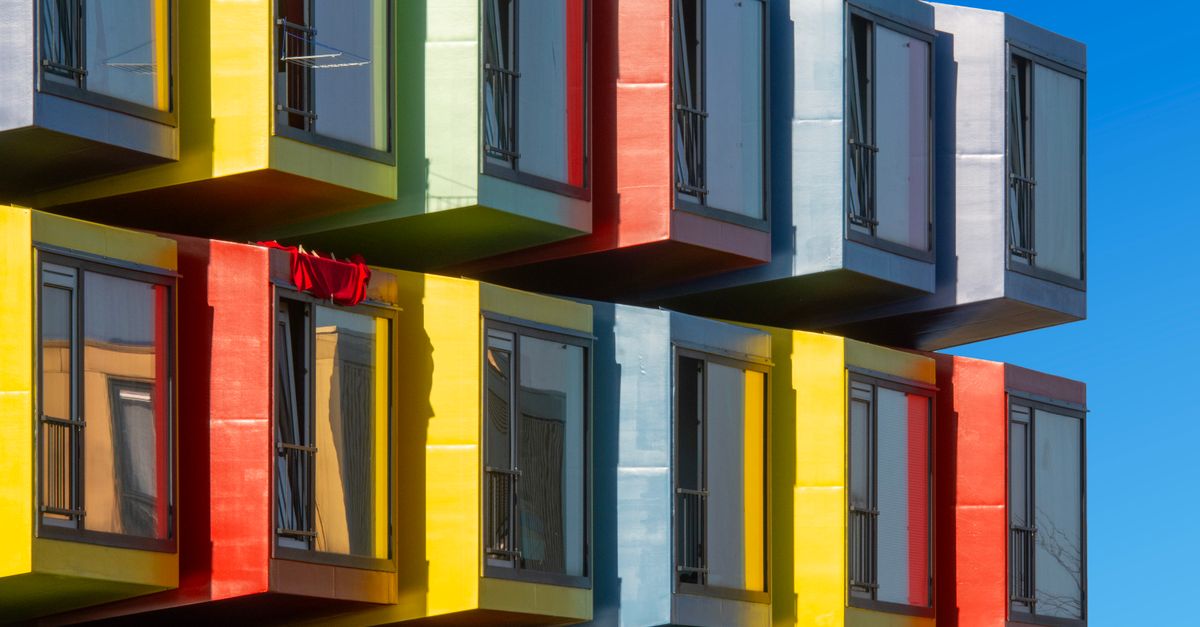 Vibrant modular apartment building with colorful facade and windows.