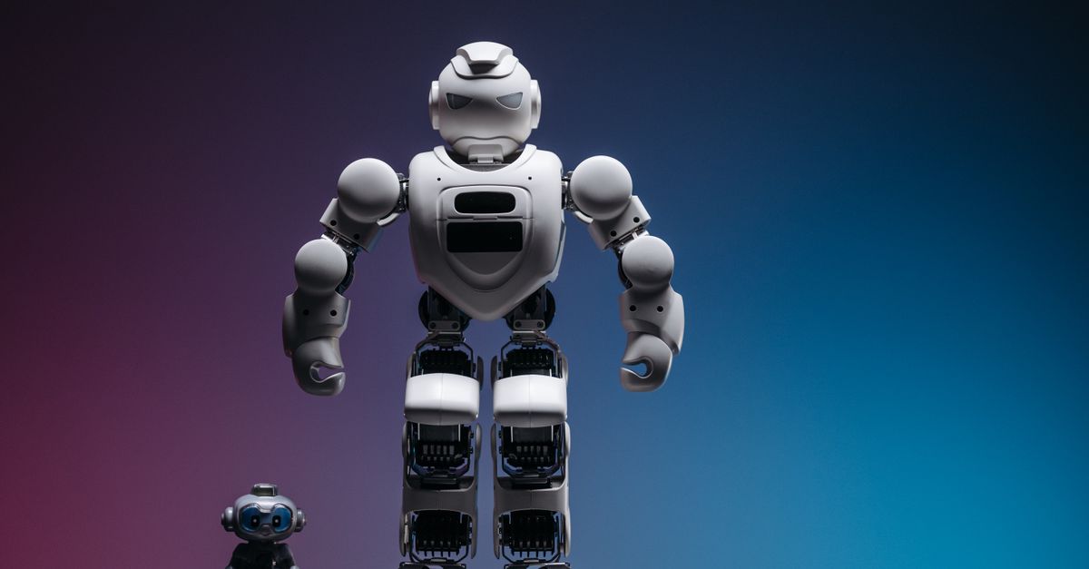 Close-up shot of two white robots displayed on a colorful gradient background symbolizing innovation in robotics.