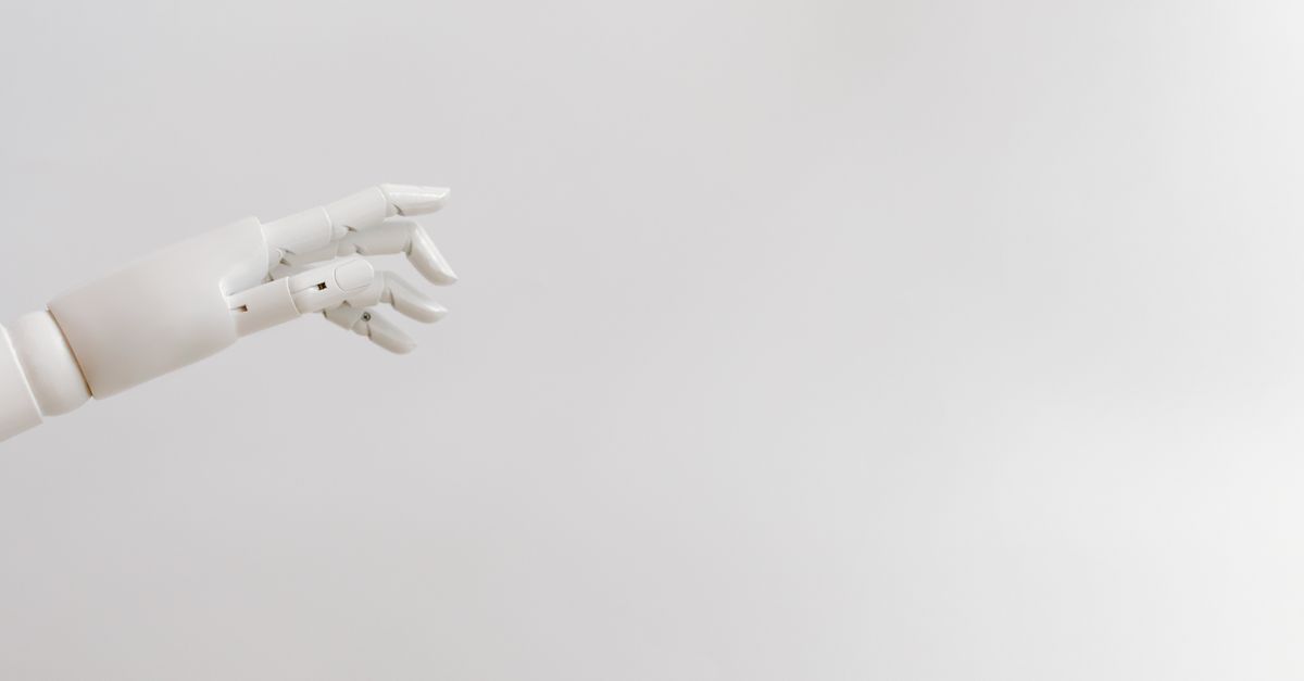 Minimalist image of a robotic hand reaching out on a white background.