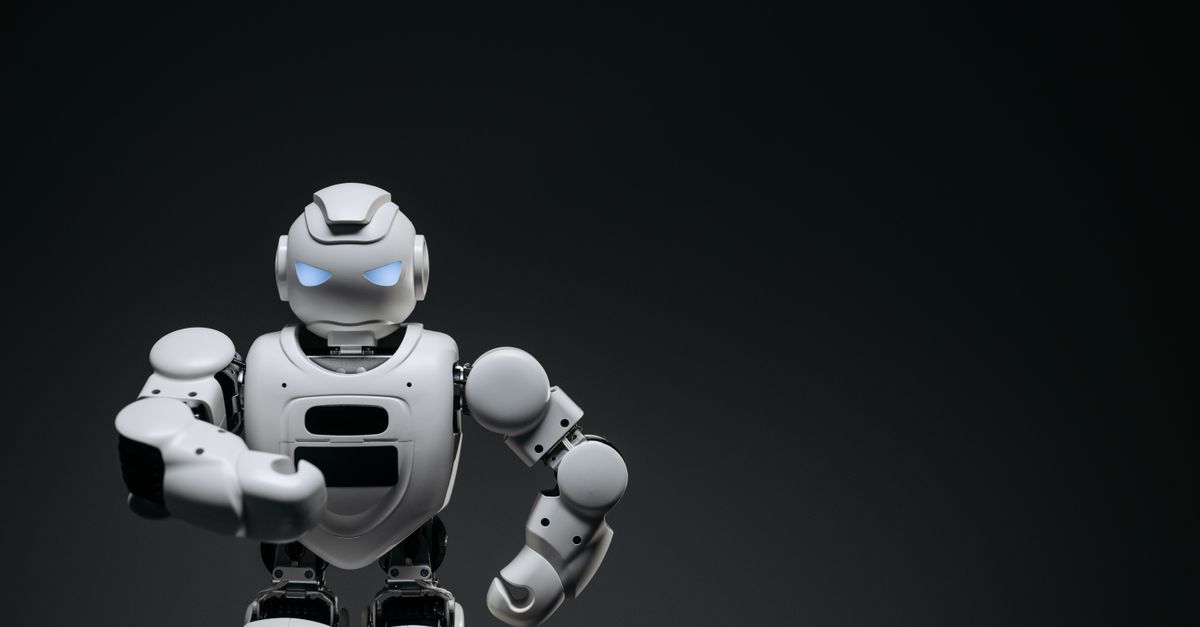 A sleek white robot showcasing modern robotics technology against a dark backdrop.