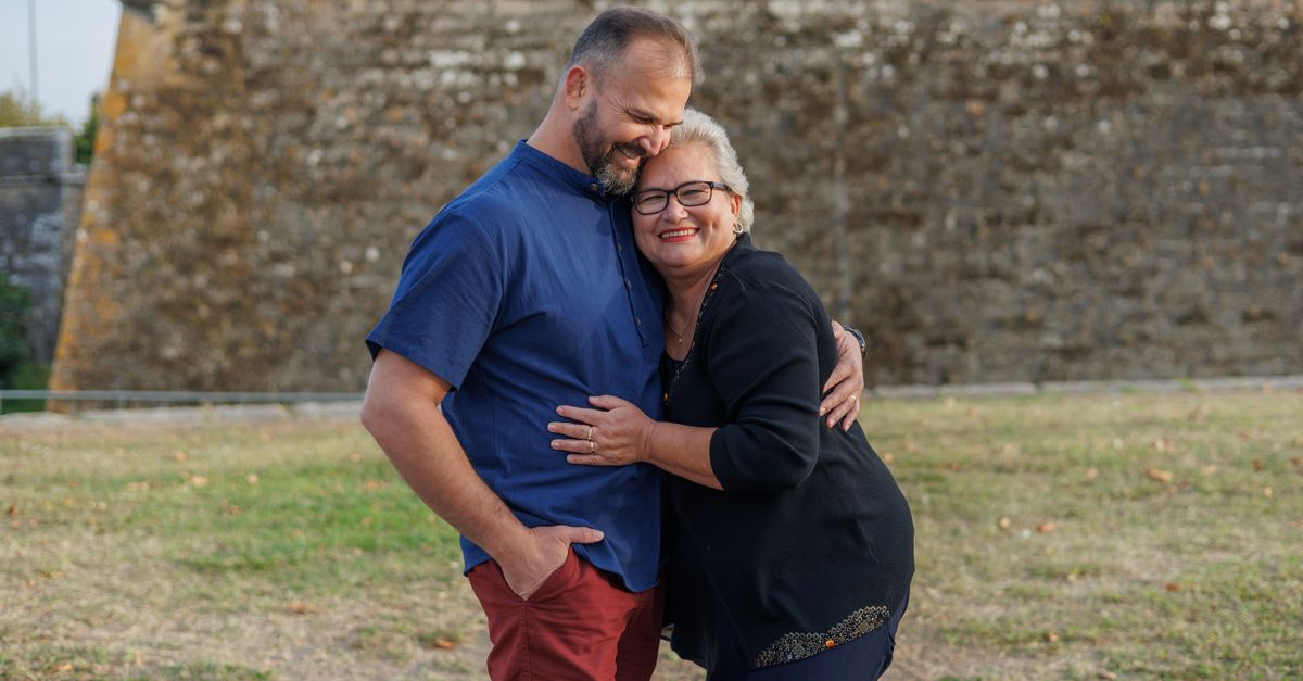 A mother and son sharing a joyful embrace outdoors in Ponte de Lima, Portugal.