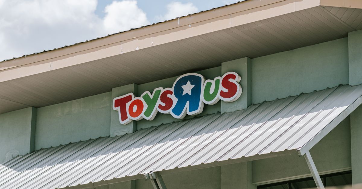 Roof and sign of a Toys R Us store on a sunny day with blue sky.