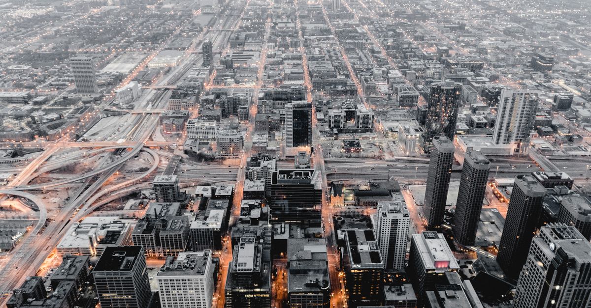 Stunning aerial cityscape of Chicago showcasing its urban structure and illuminated streets at dusk.
