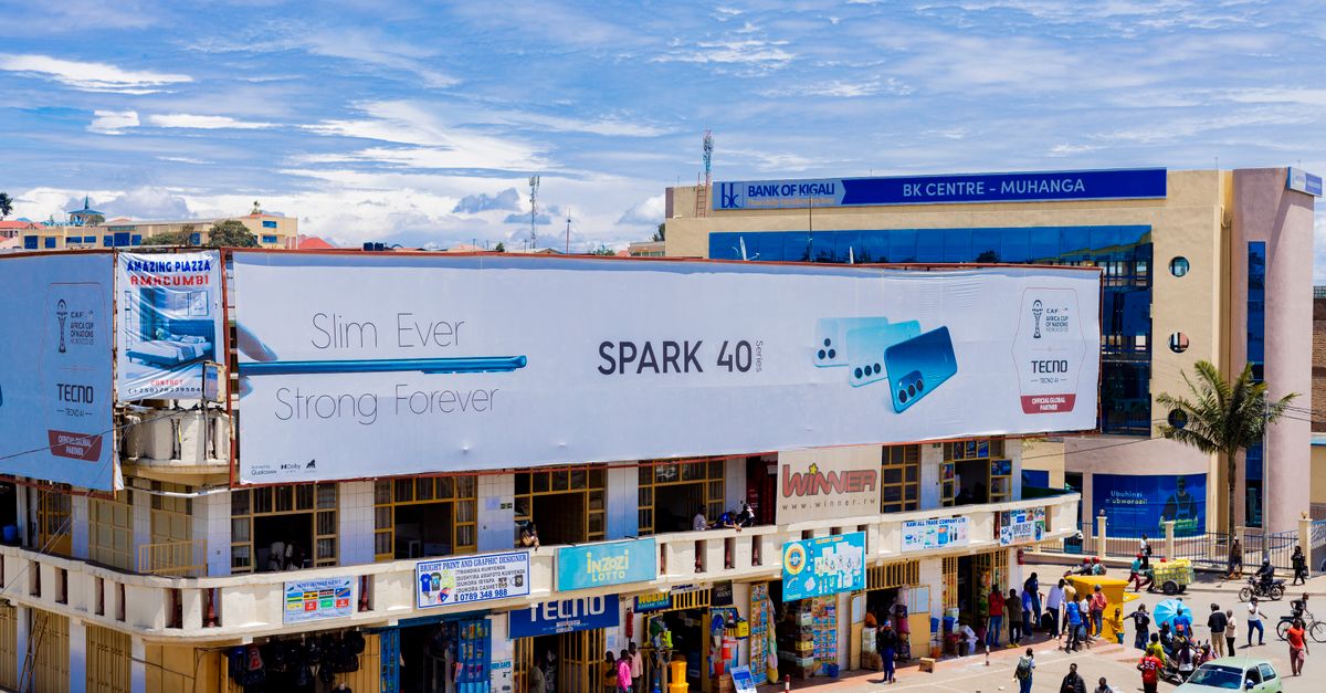 Vibrant city street scene in Muhanga, Rwanda, with people and colorful advertising.