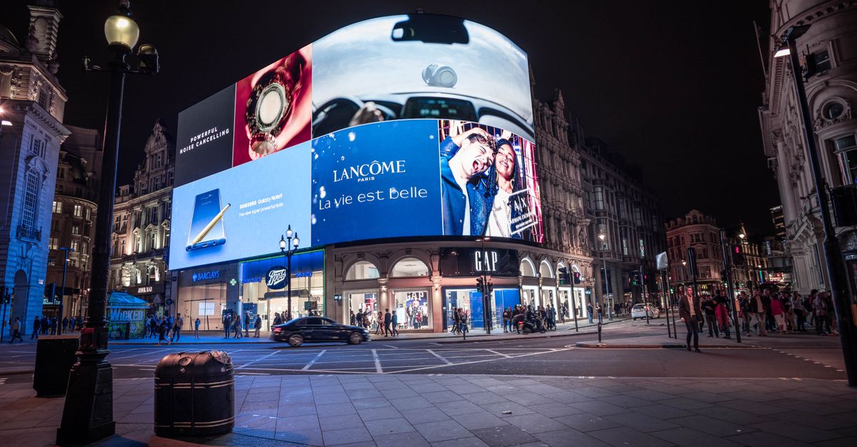 Night view of illuminated billboards at Piccadilly Circus, showcasing vibrant city life in London.