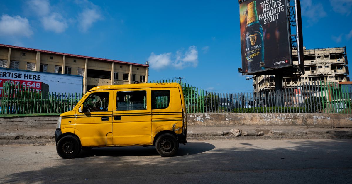 Dynamic street scene in Lagos featuring the iconic yellow danfo bus and urban backdrop.
