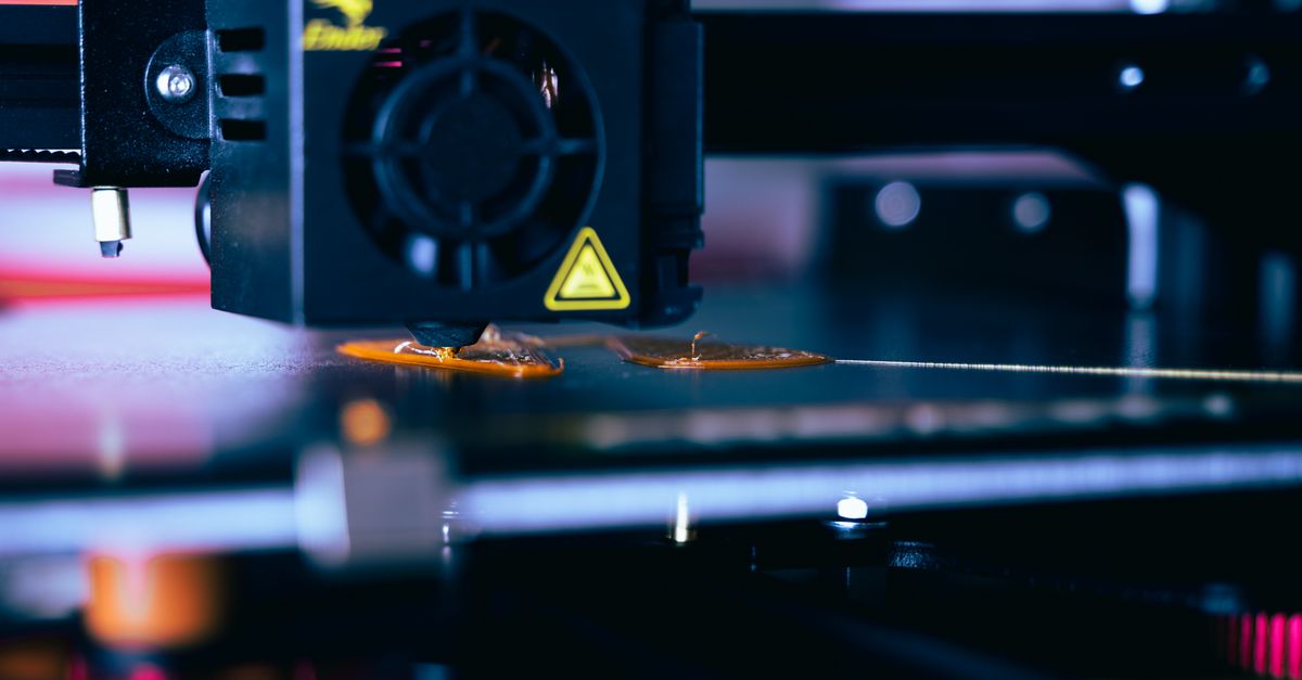 Detailed view of a 3D printer head during operation, showcasing modern printing technology.