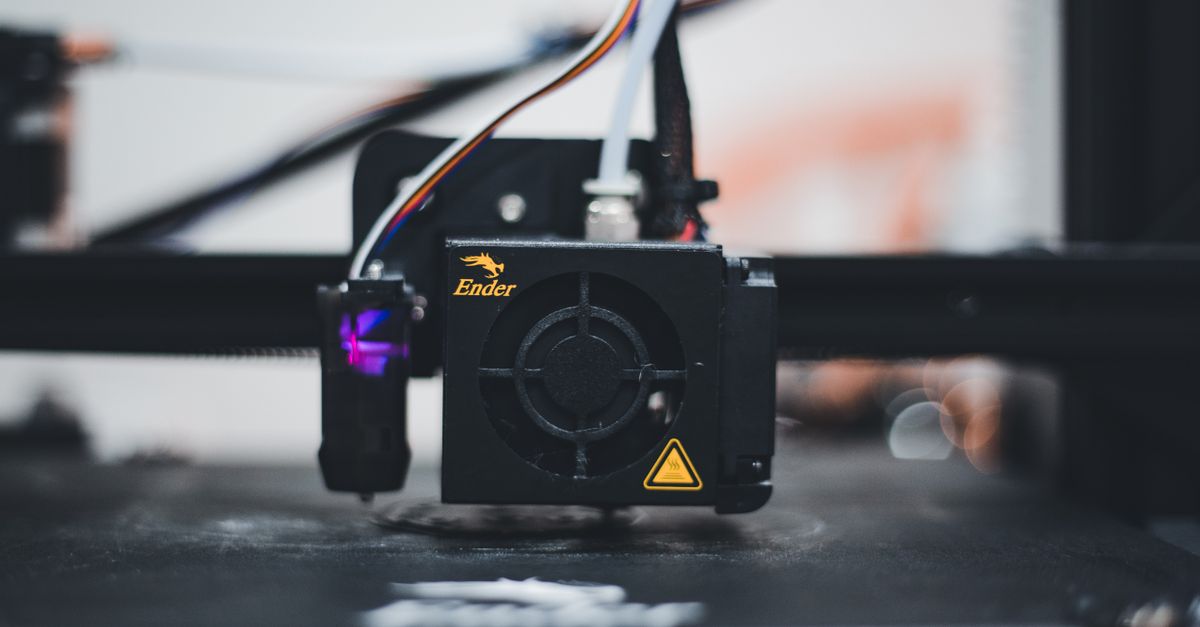 Detailed view of a 3D printer nozzle during the printing process, showcasing advanced technology.